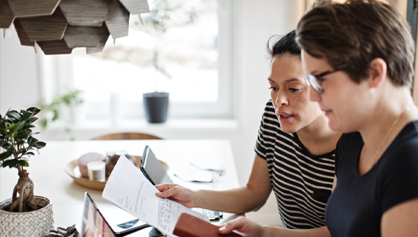 Two people working on paperwork together