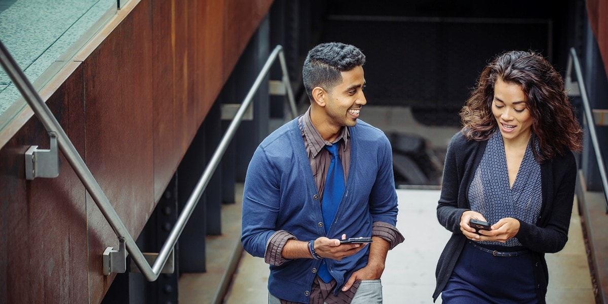 two professionals talking by staircase