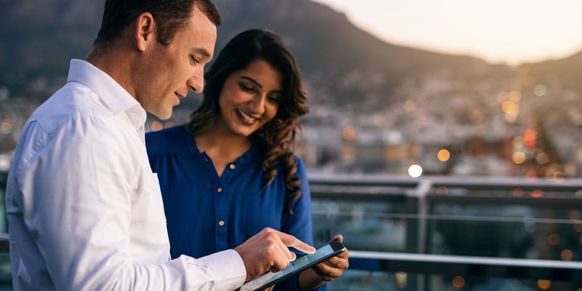 man and woman looking at phone