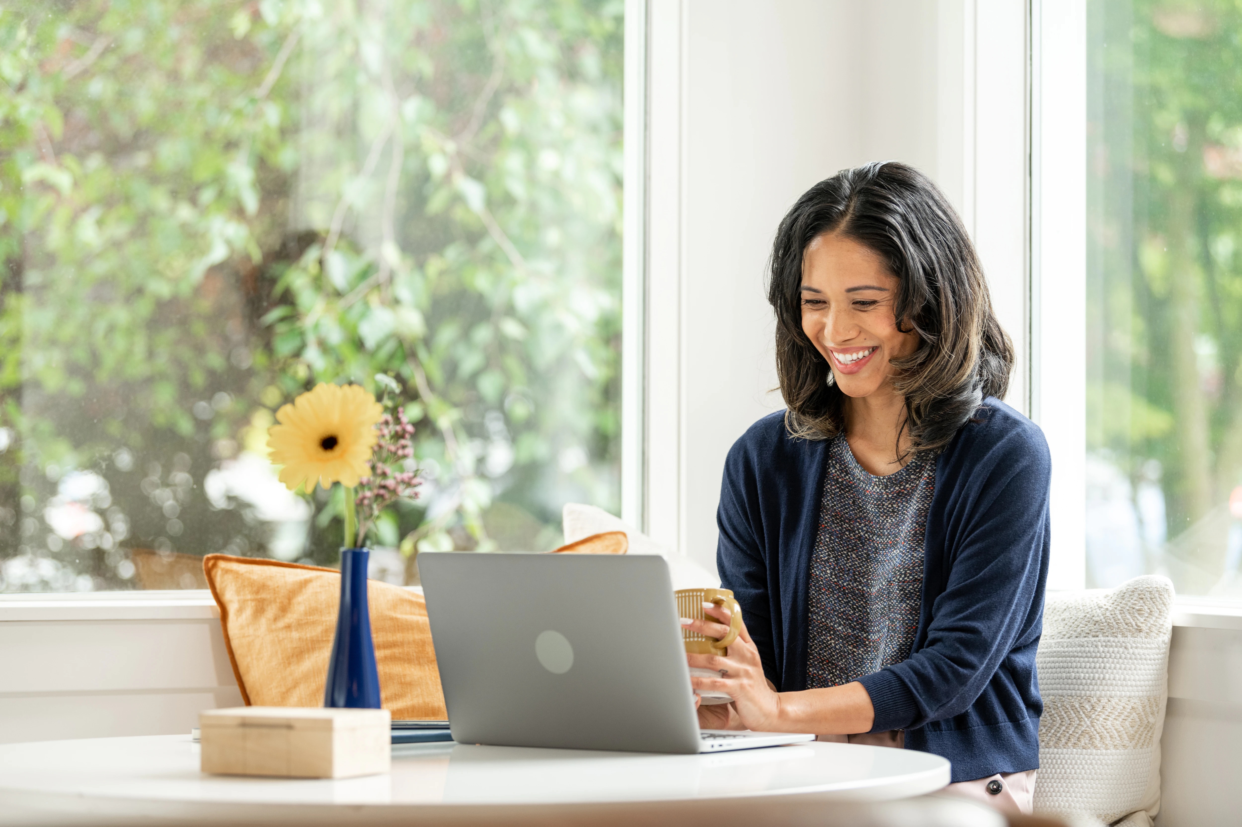 woman working at a table with a laptop