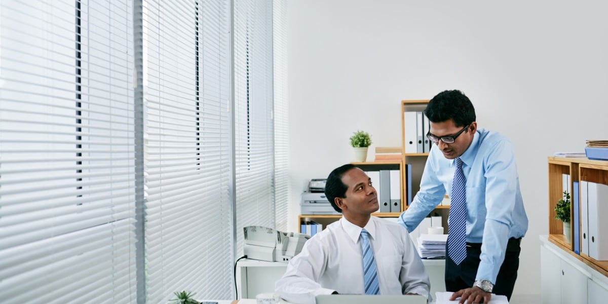 two coworkers collaborating in an office
