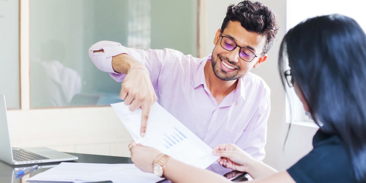 two people looking at paperwork together