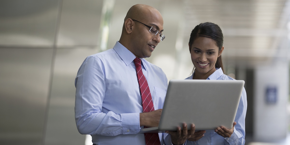 man and woman looking at a laptop