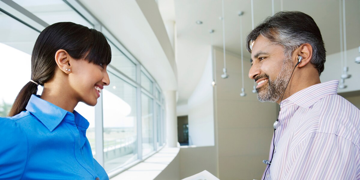 man and woman smiling in office