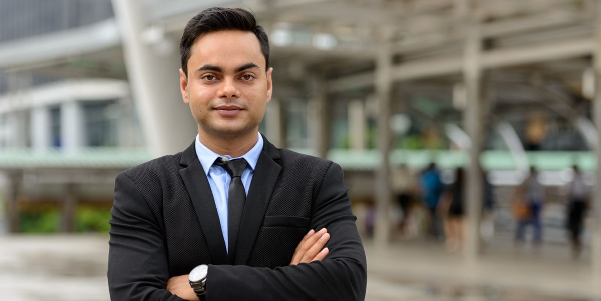 professional man standing outside with arms crossed