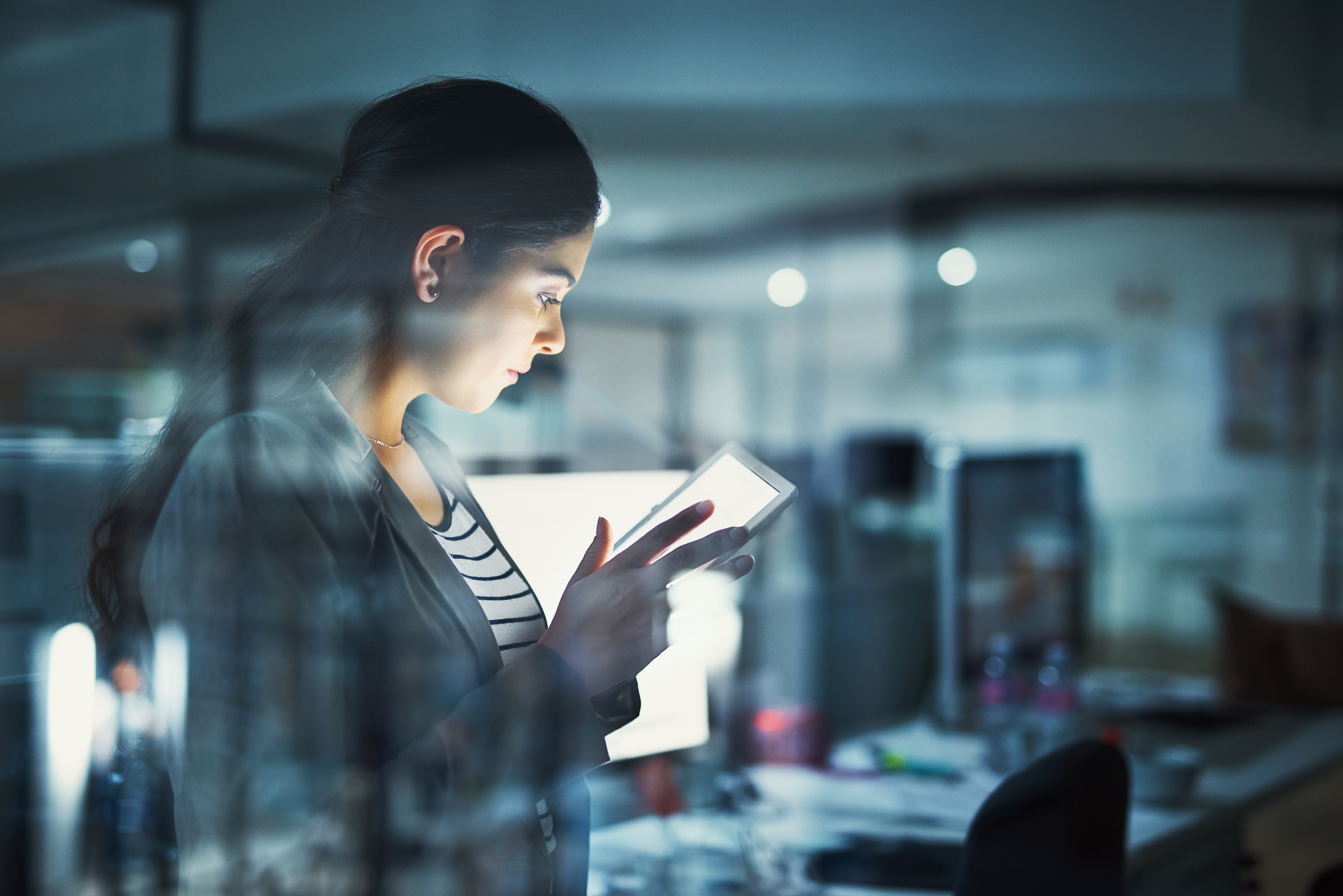 business woman looking at a tablet in an office