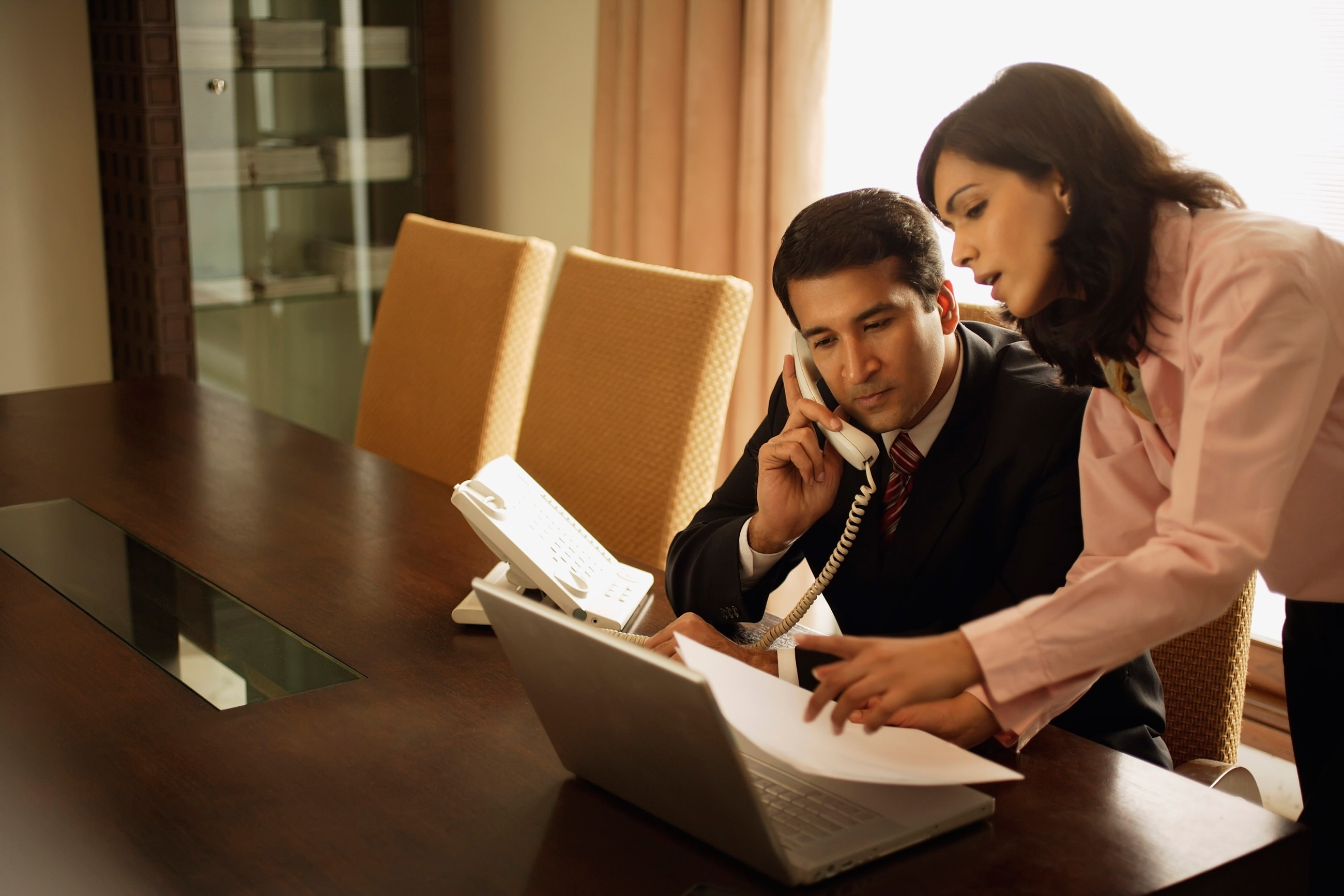 two coworkers looking at paperwork together