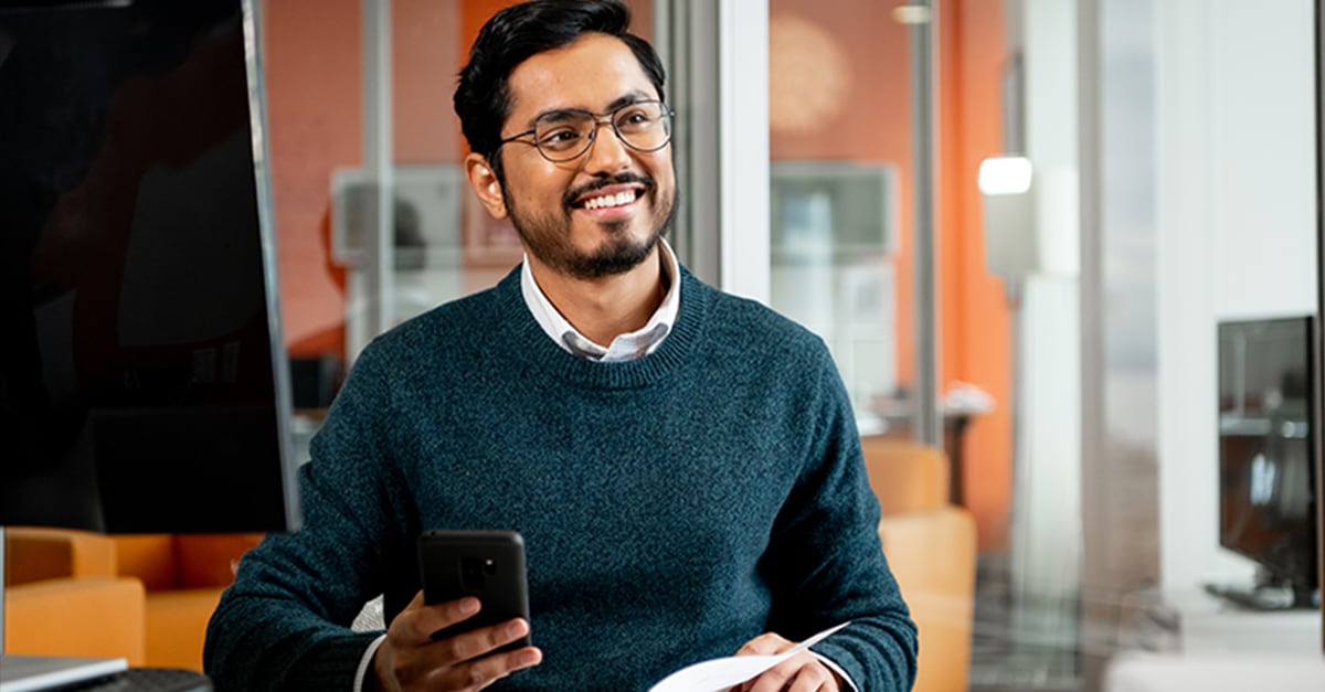 business man in the office with a phone in his hand