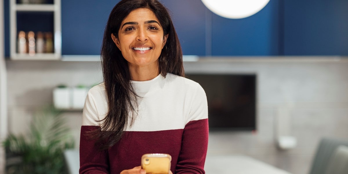 woman in office, holding phone