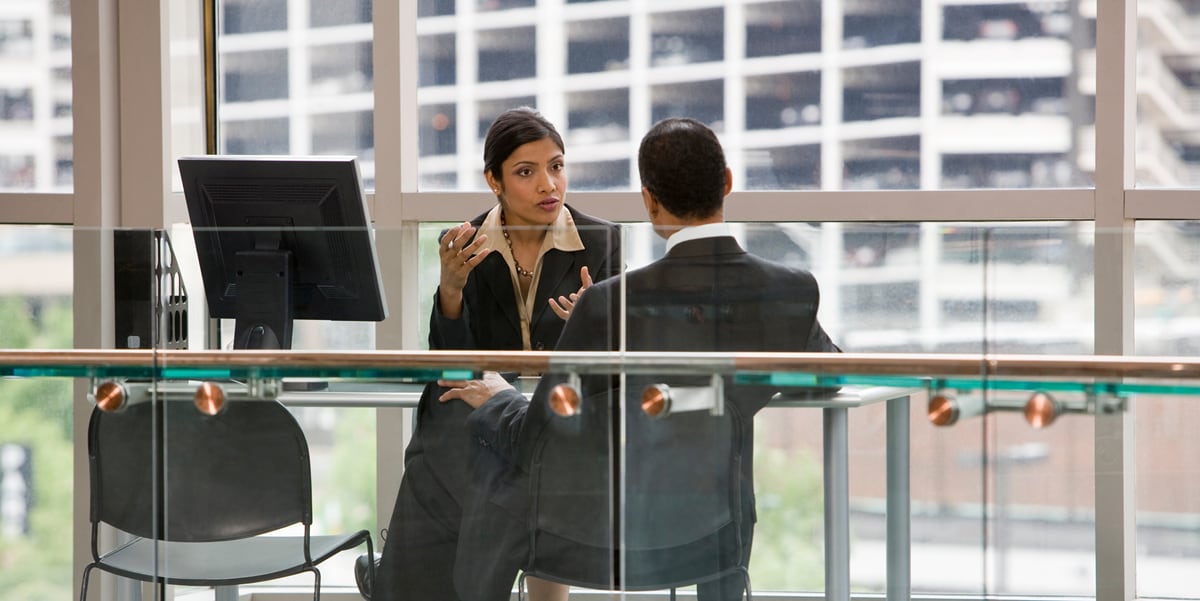 woman speaking to man in office