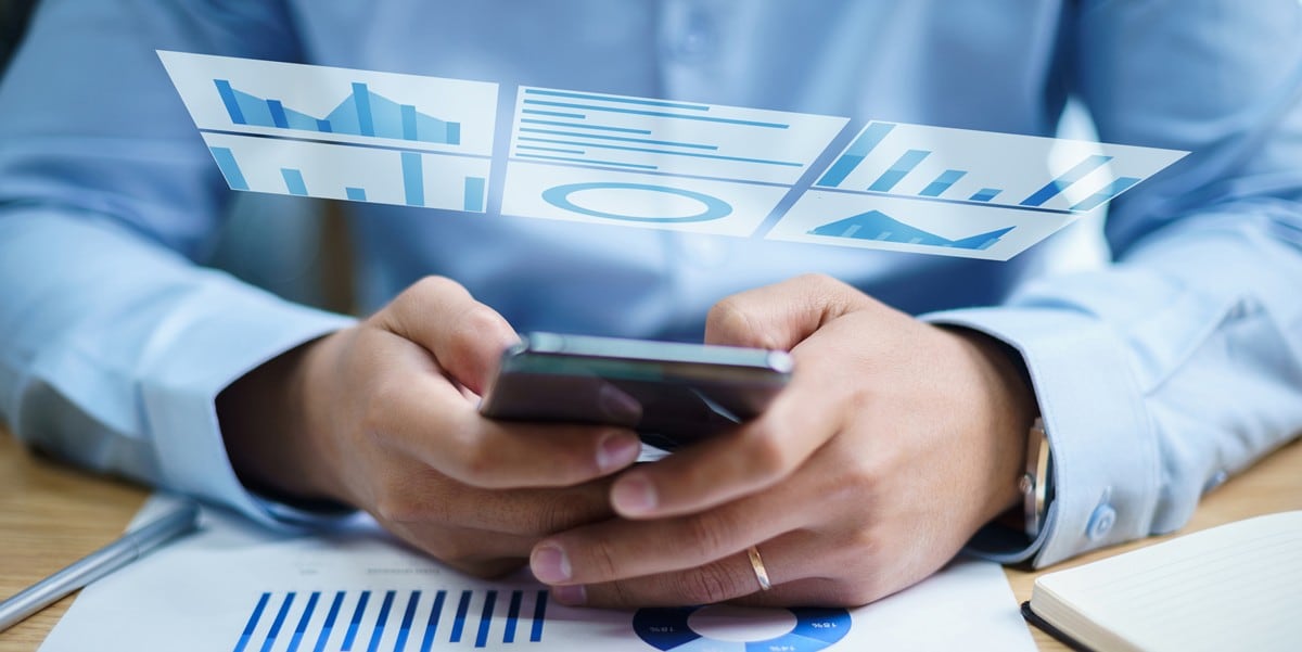 hand holding cell phone, chart graphics pop up