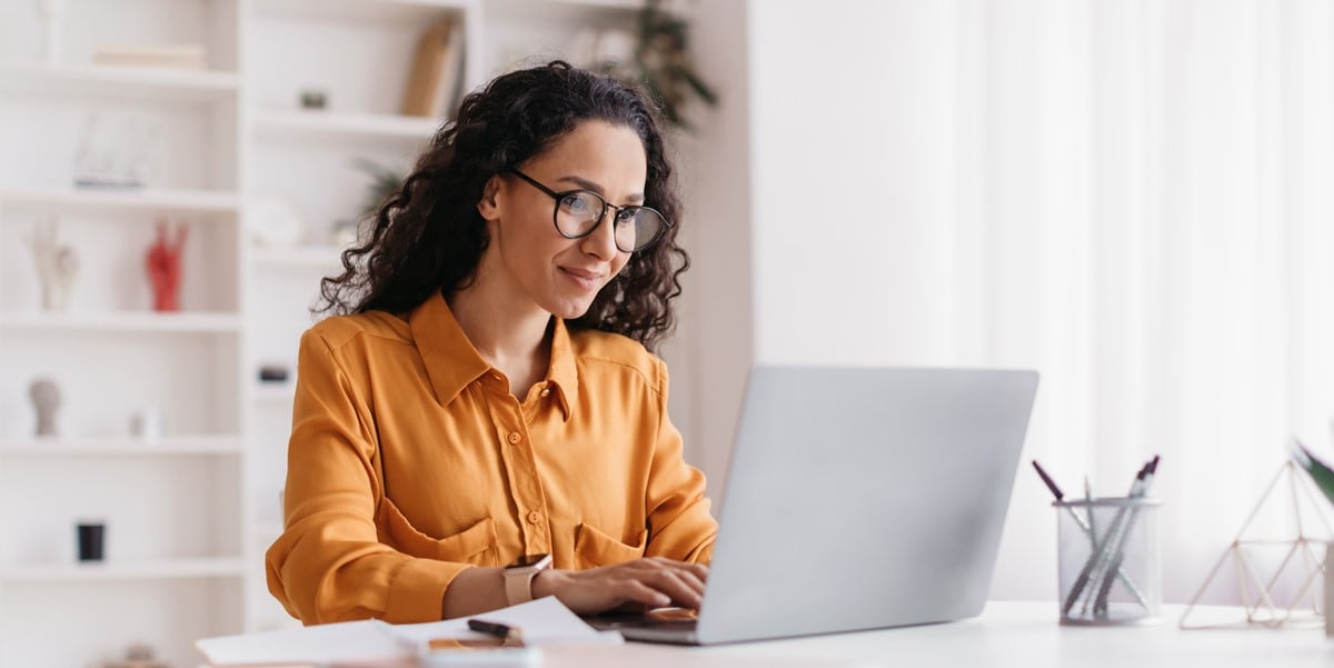 woman working at a desk using laptop