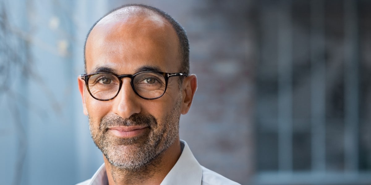 professional man smiling, in the office