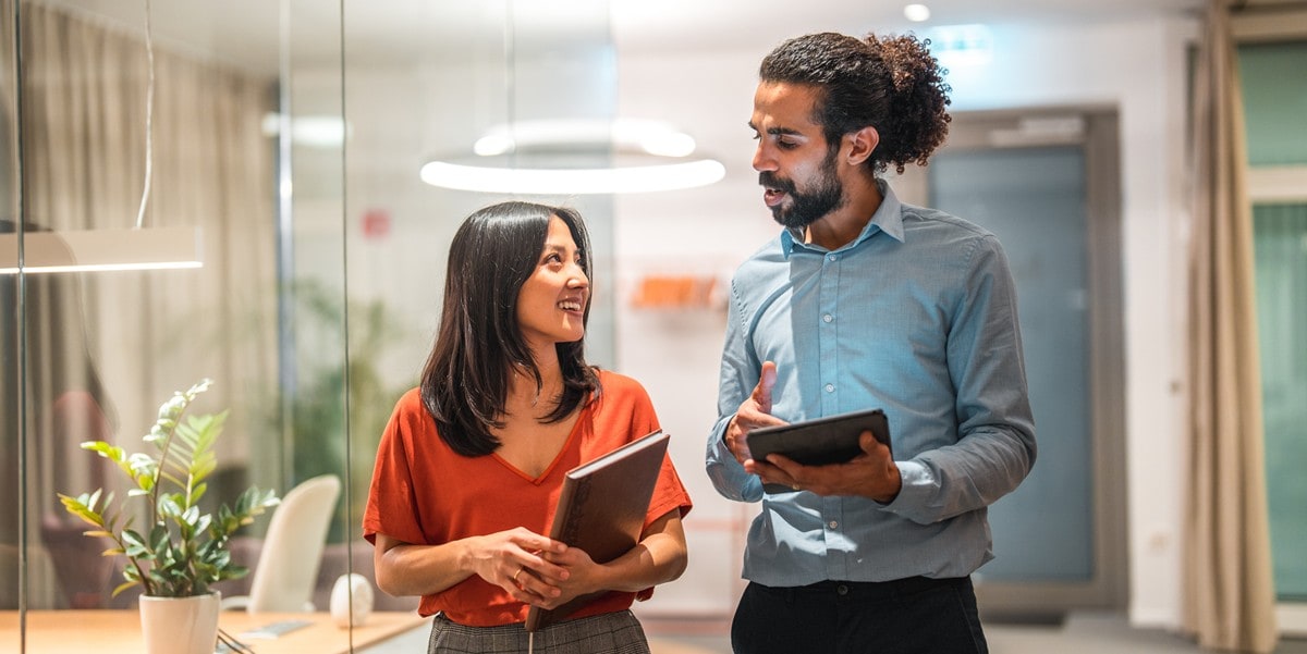 two professionals in the office with tablets