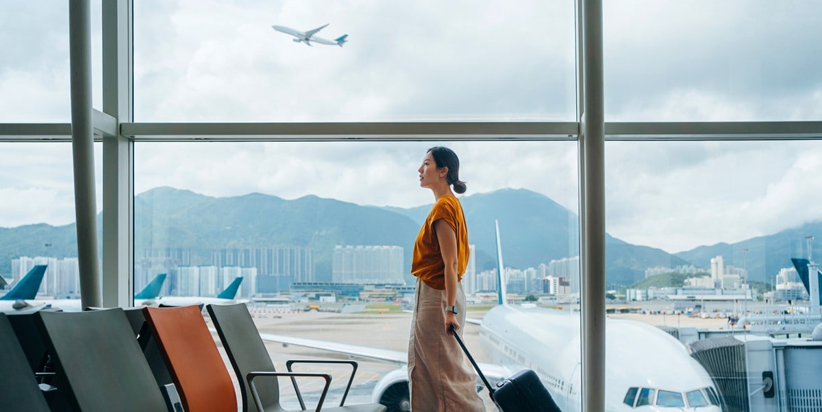 woman traveler at airport with luggage