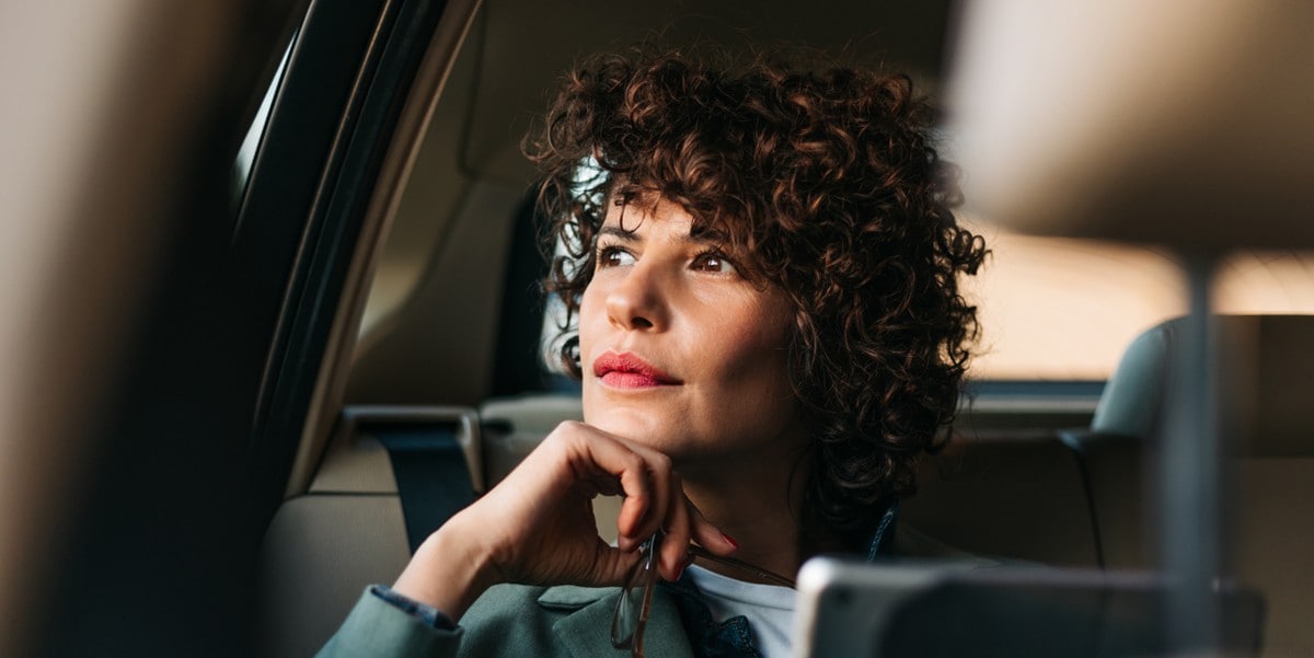woman in a car, looking out window