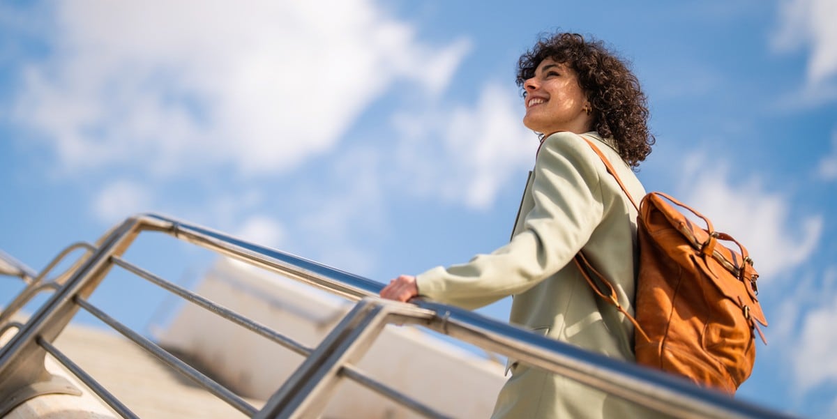 woman traveler with backpack going up stairs