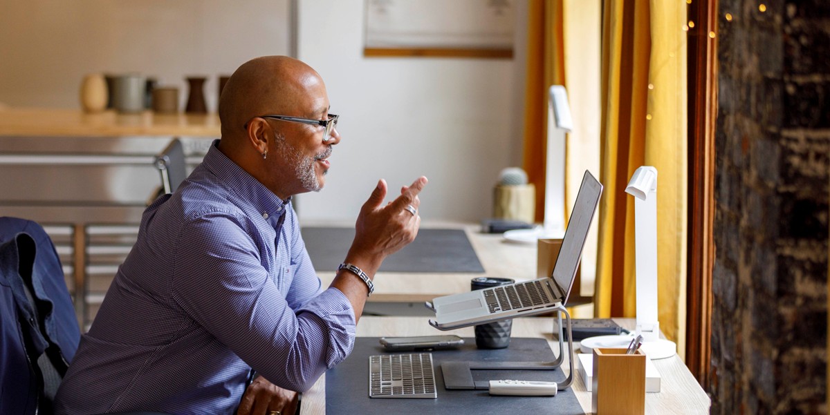 man working at a desk, using computer