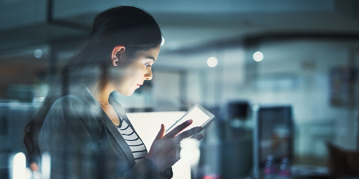 business woman looking at a tablet in an office