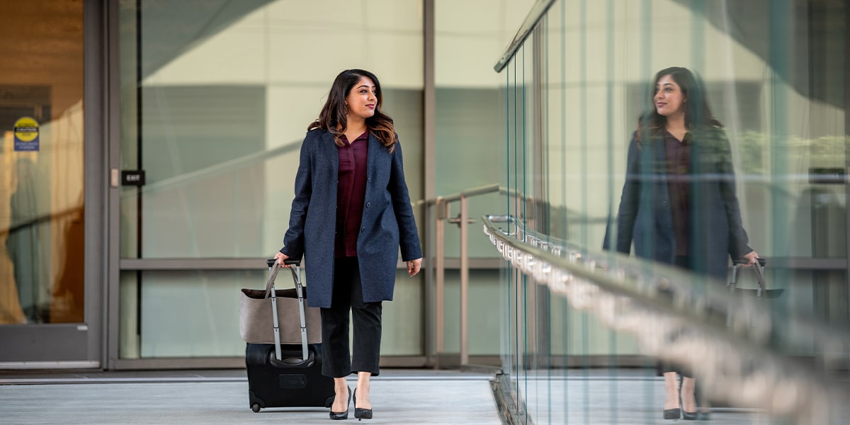 woman business traveler walking with her suitcase