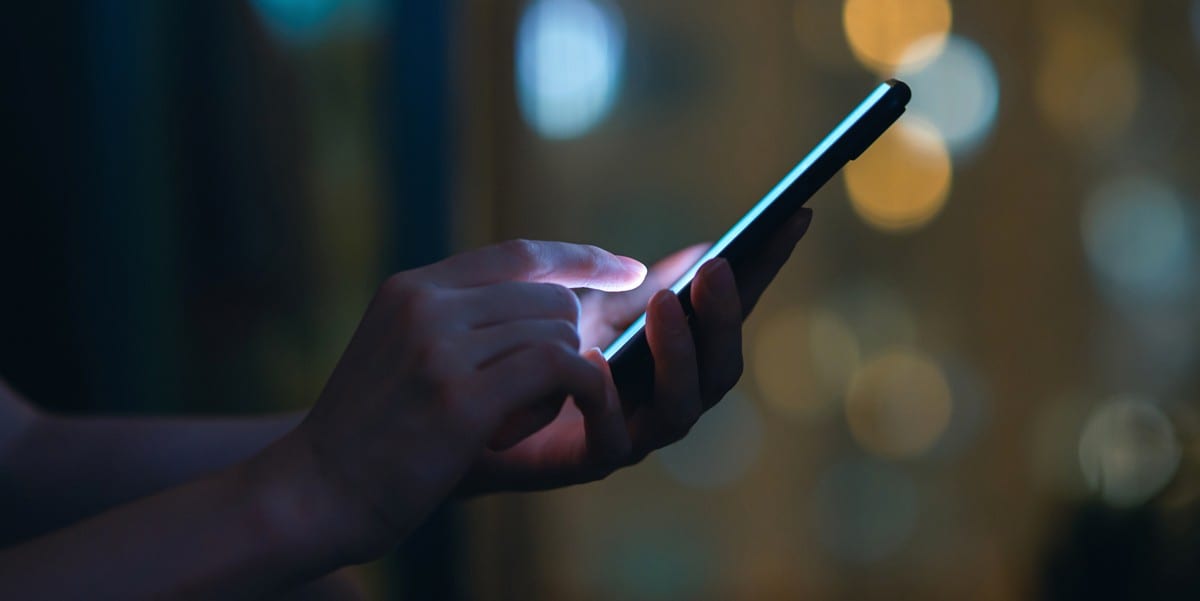 person hand holding cellphone