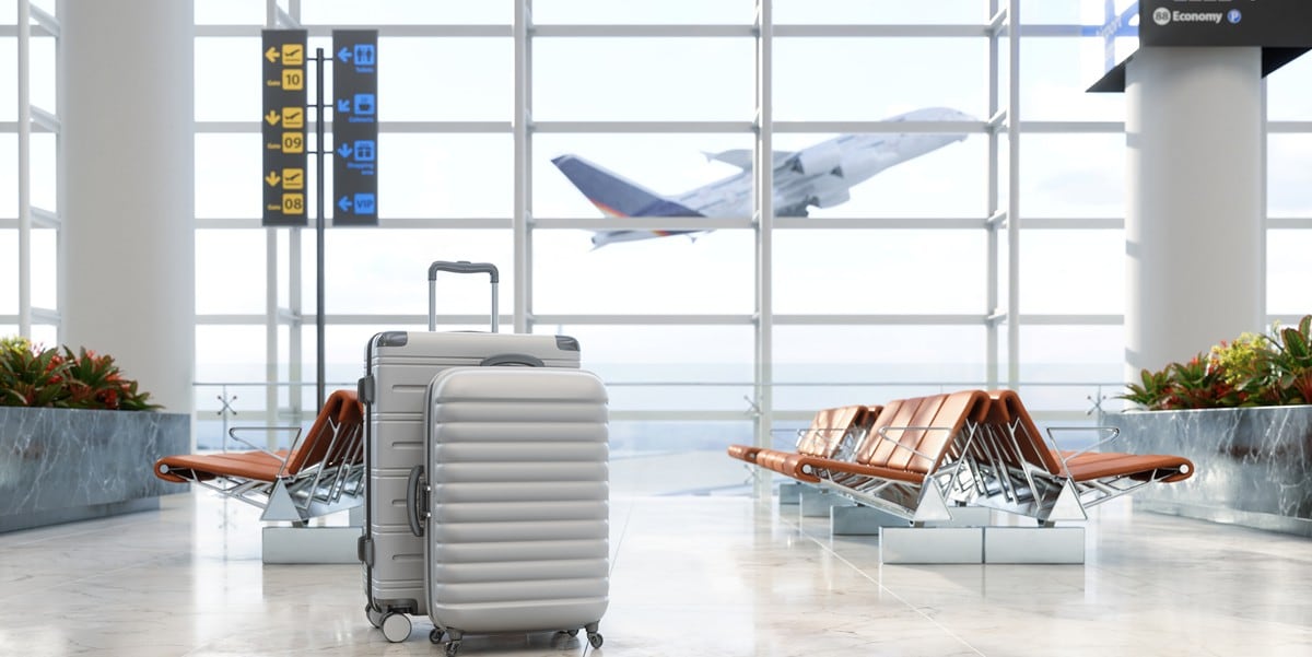 airport lounge, two suitcases, past the window a plane taking off 