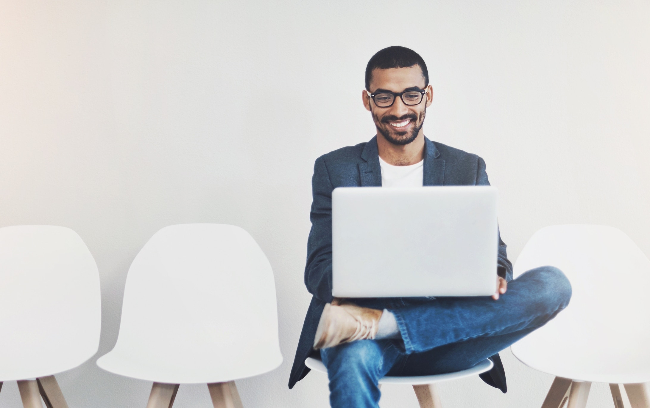 Laughing man using laptop