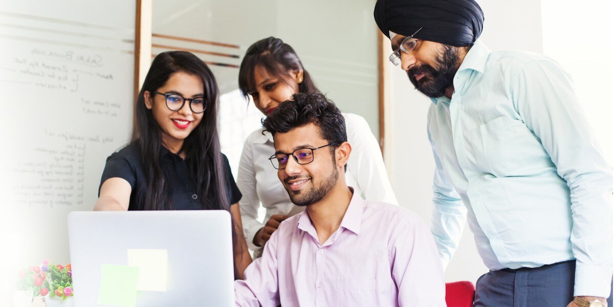 business people collaborating together around a laptop