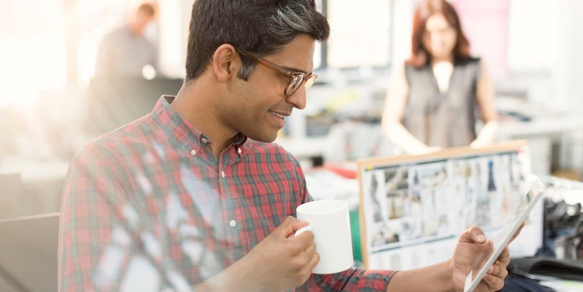 man reading document in office