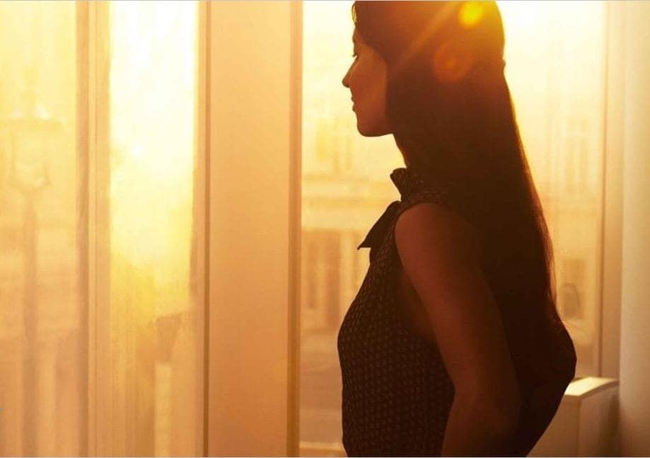woman looking out of the window at the office