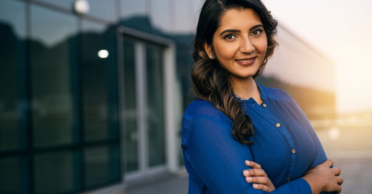 woman smiling with an office in the background